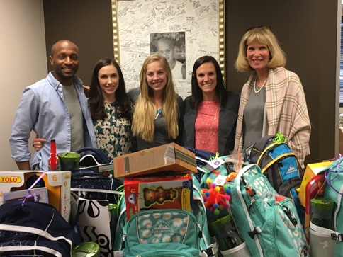 Heidi Culbertson (far right) stands with Northwestern Mutual Recruiters behind some of the Bags of Fun.