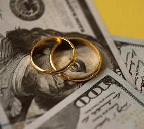 wedding rings on one hundred dollar bills